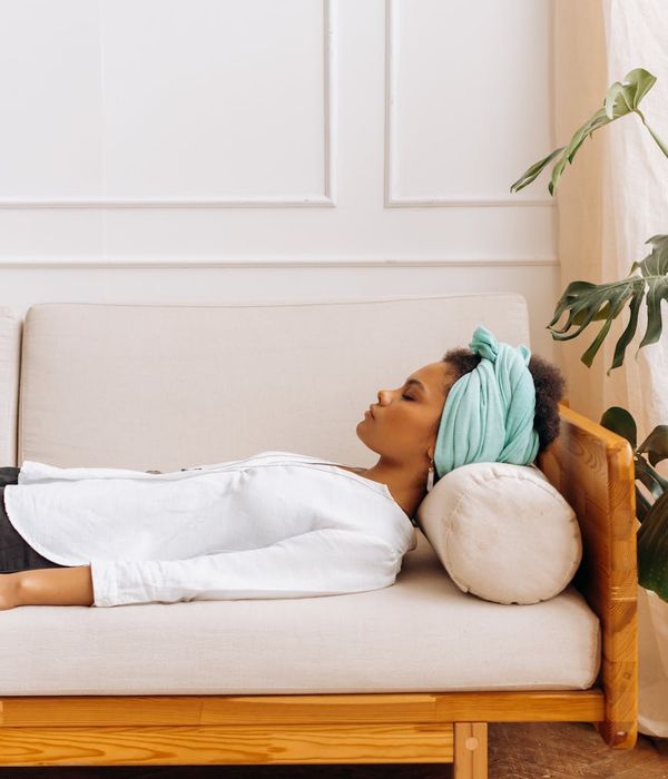 Woman in a calm yoga pose, surrounded by a serene atmosphere.